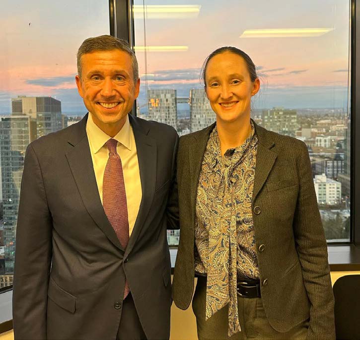 A photo of Katie Wilson posing with DNC Chair Ken Martin